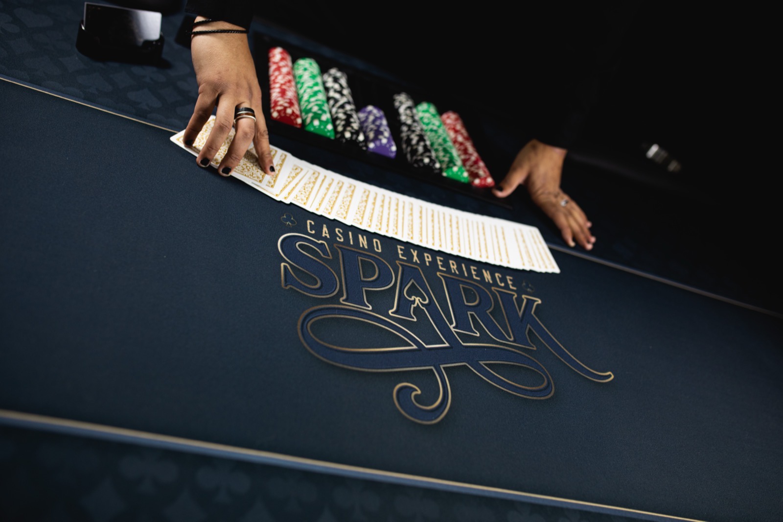 Card fan on the custom Spark casino felt